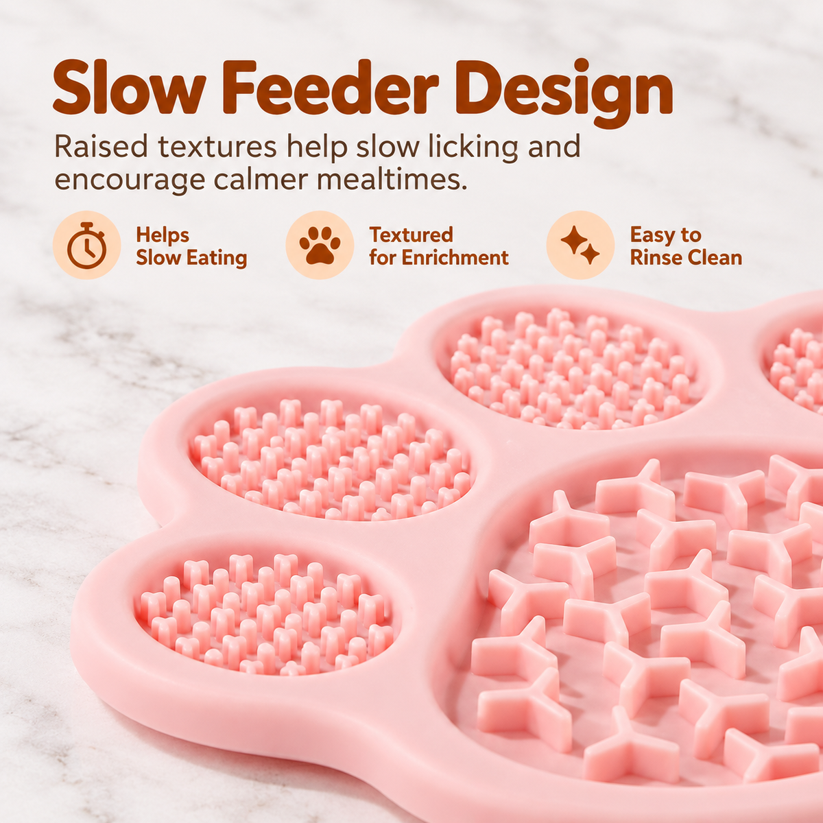 Close-up of the pink paw-shaped lick mat's textured sections