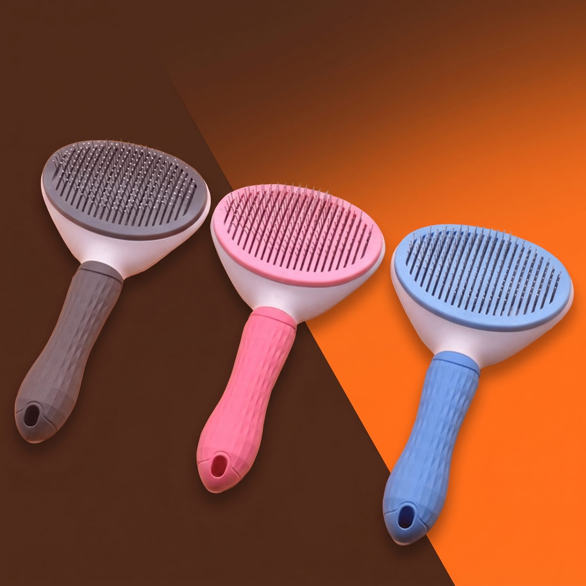 Three slicker brushes in mauve, pink and blue on a dark background