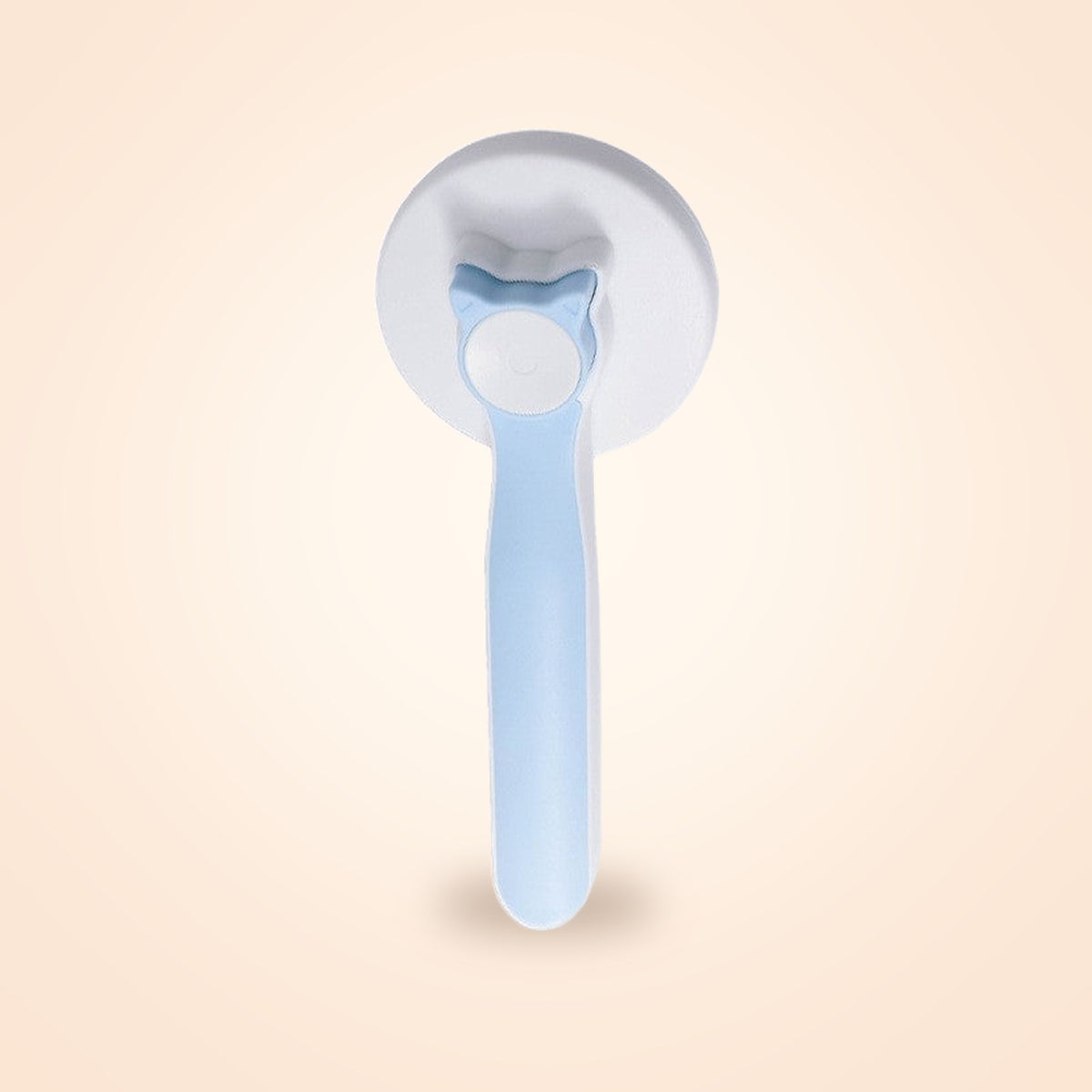 Cat-ear shaped self-cleaning slicker brush in white and blue, on a warm cream background