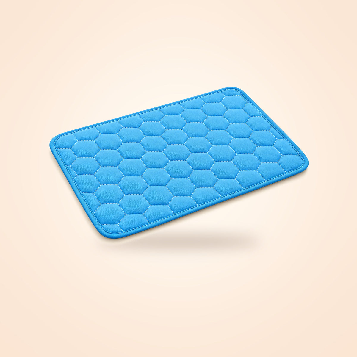 Blue honeycomb-quilted washable cooling mat for dogs and cats, on a warm cream background