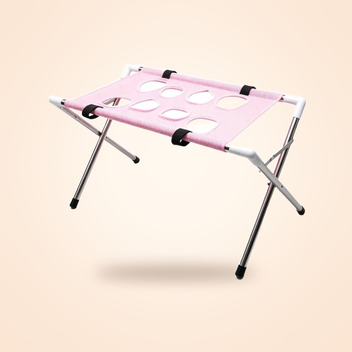 Folding pet bathing and grooming rack with pink mesh top, on a warm cream background