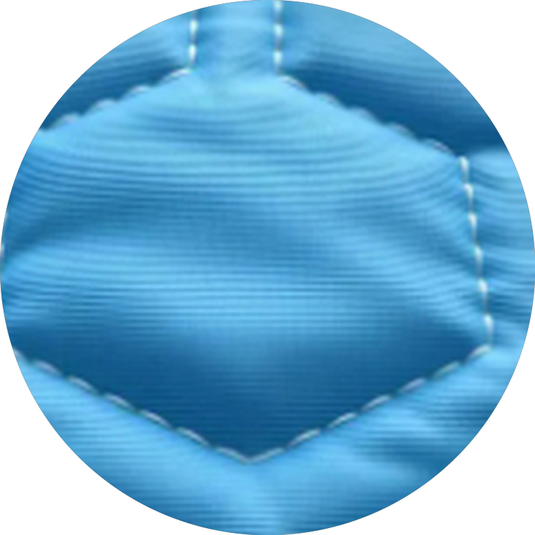 Close-up of one quilted honeycomb cell on the blue cooling mat, showing the stitched outline and the soft raised fabric inside it