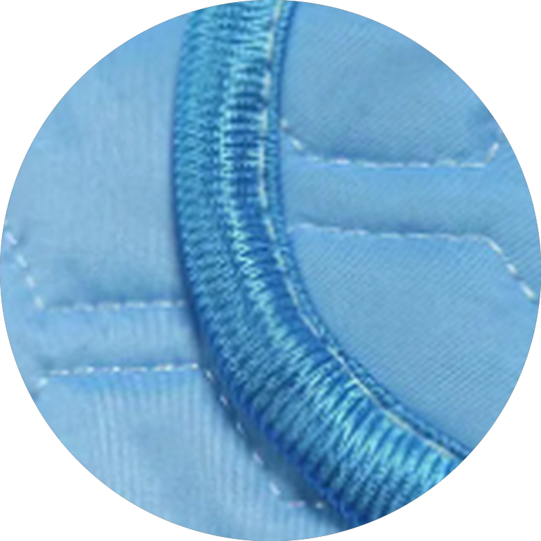 Close-up of the cooling mat's finished piped edge, showing the bound trim stitched around the corner of the pad