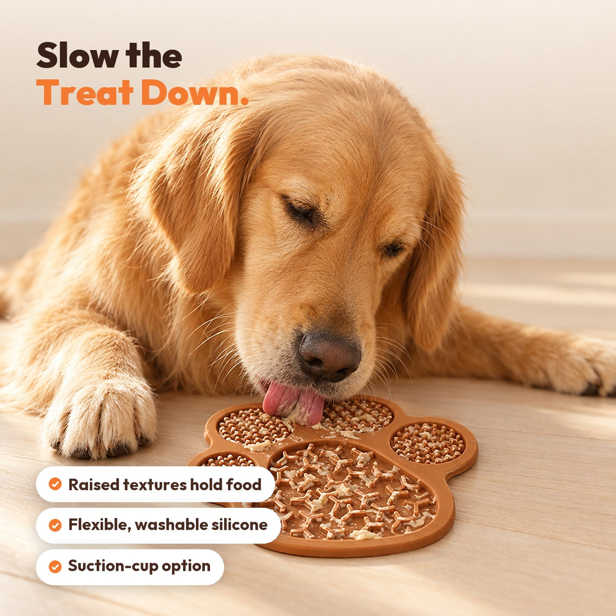 Golden Retriever licking a brown paw-shaped silicone lick mat on the floor
