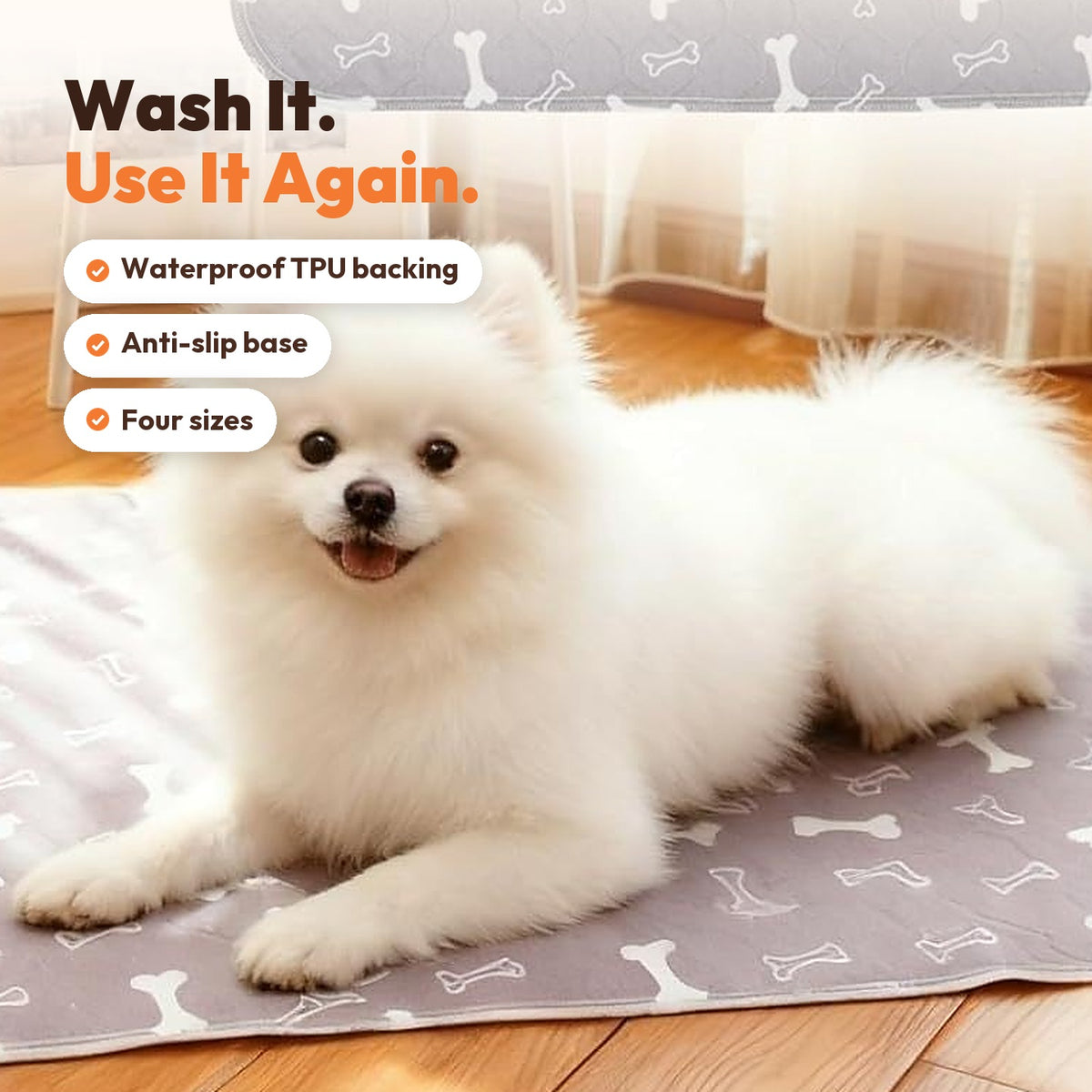 White Pomeranian lying on a gray bone-print washable pee pad
