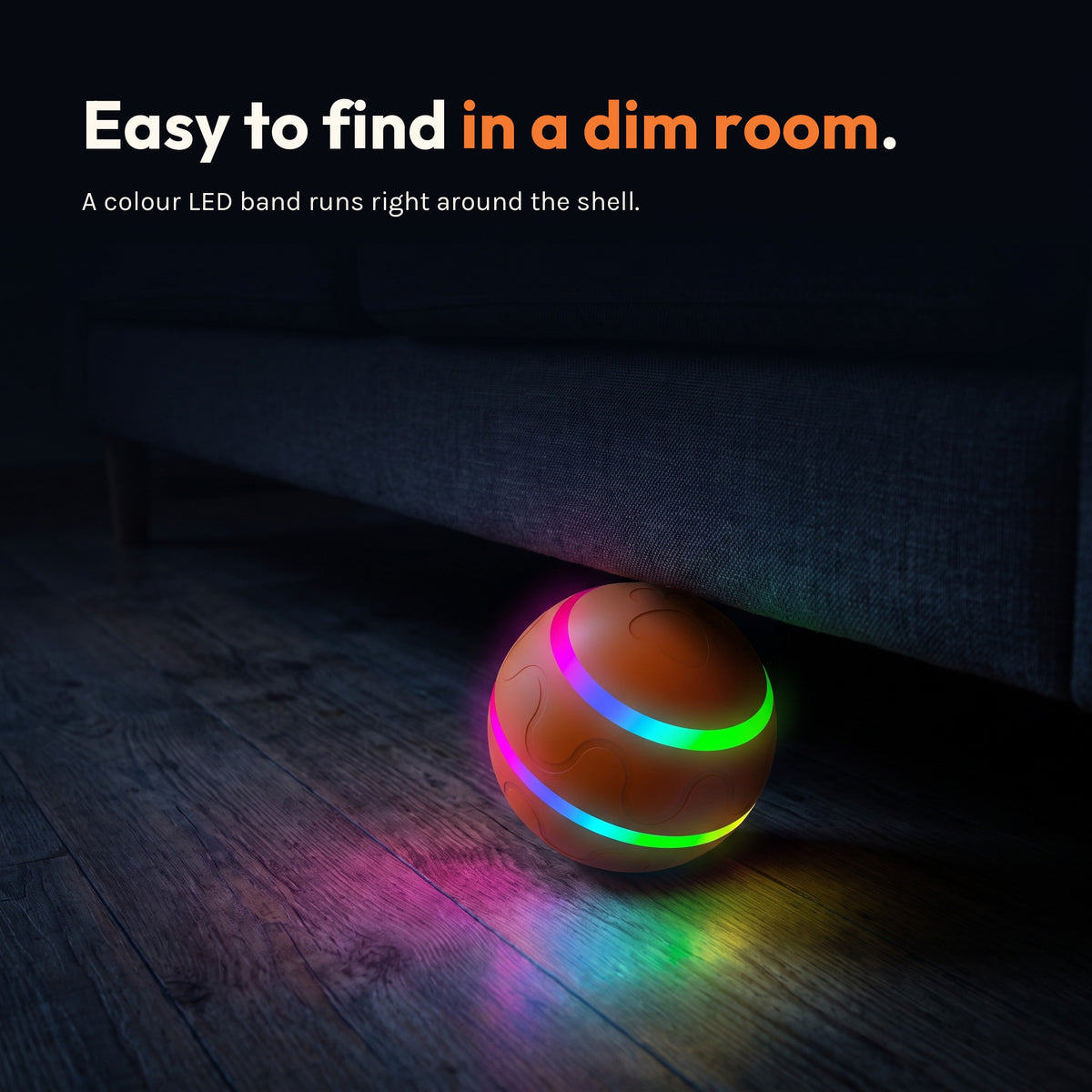 The ball in a dark room with its colour LED band glowing and casting light on the floor. Caption: easy to find in a dim room.