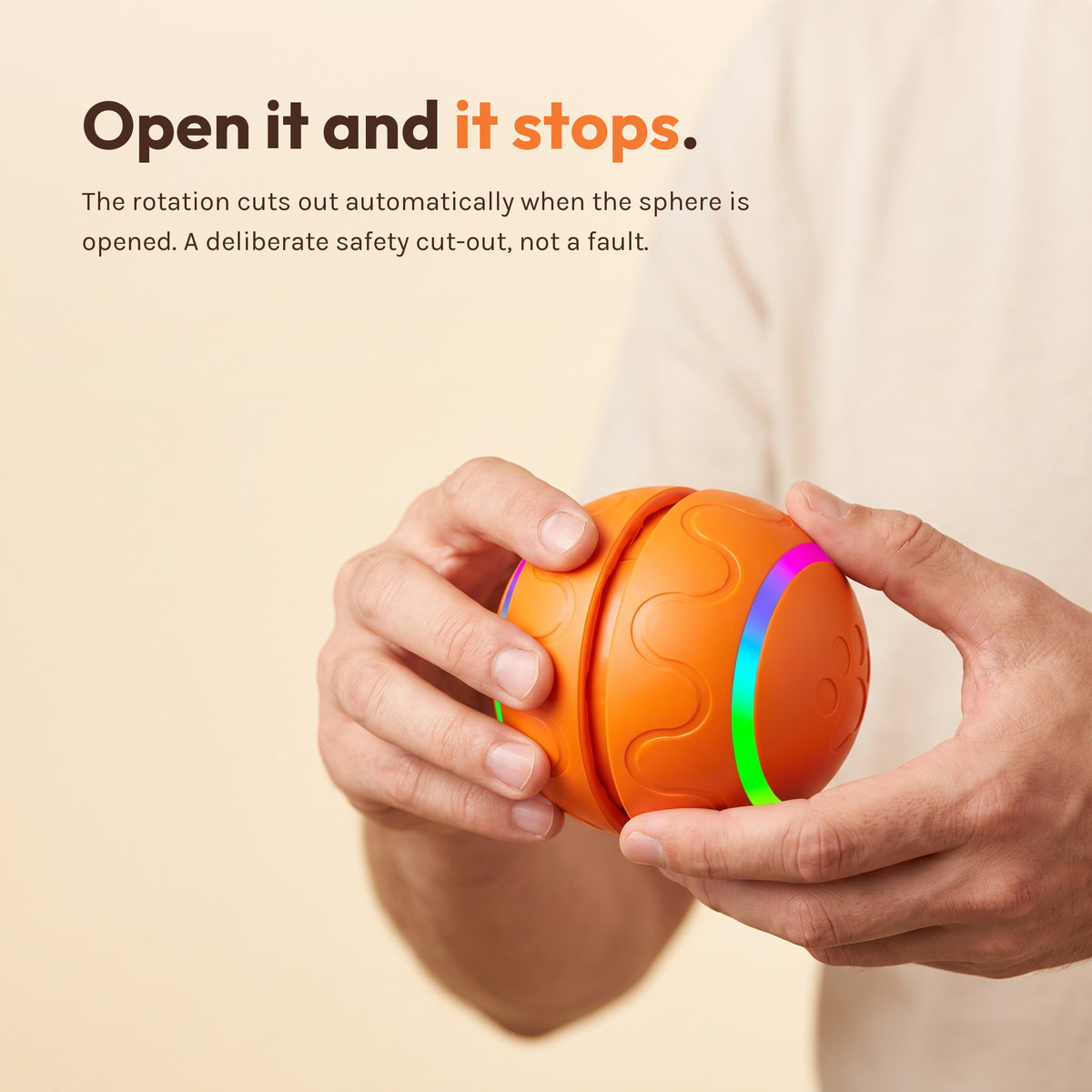 Two hands holding the orange ball as if to twist it open. Caption: open it and the rotation stops automatically, a deliberate safety cut-out.