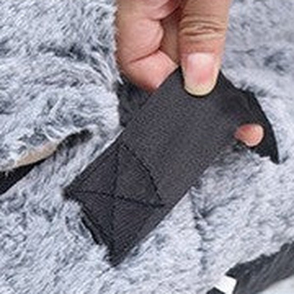 Close-up of the stitched carry handle on the side of the bed