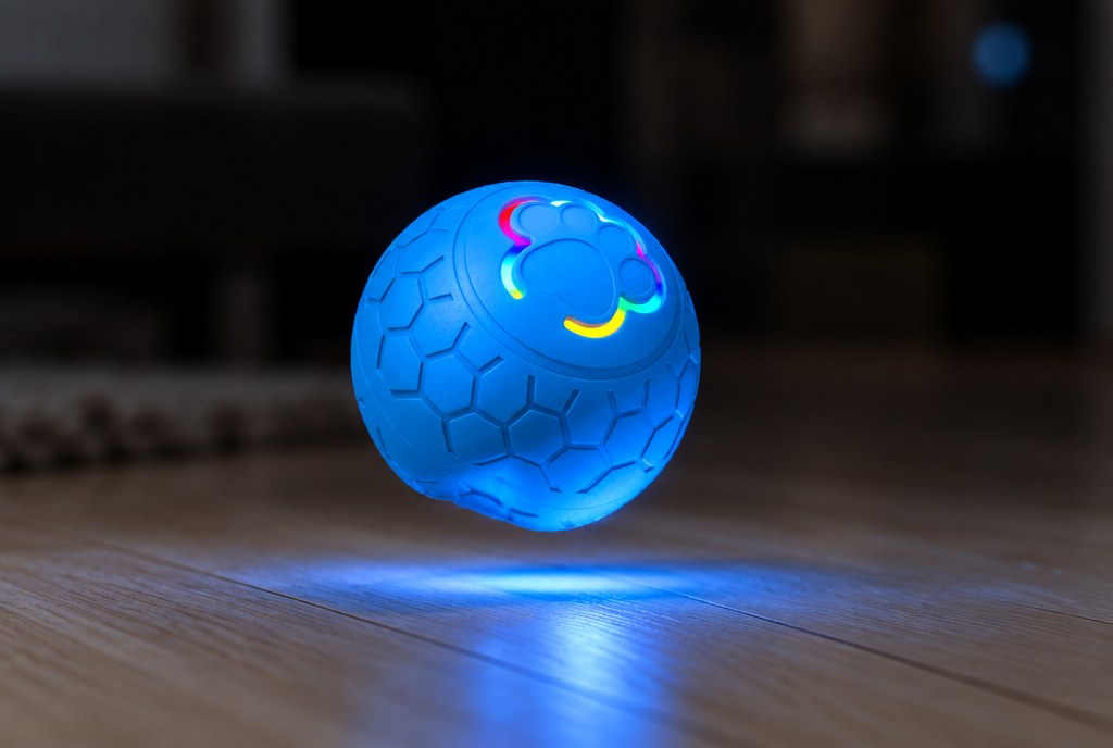 The ball caught mid-bounce with its light throwing a pool onto the floor