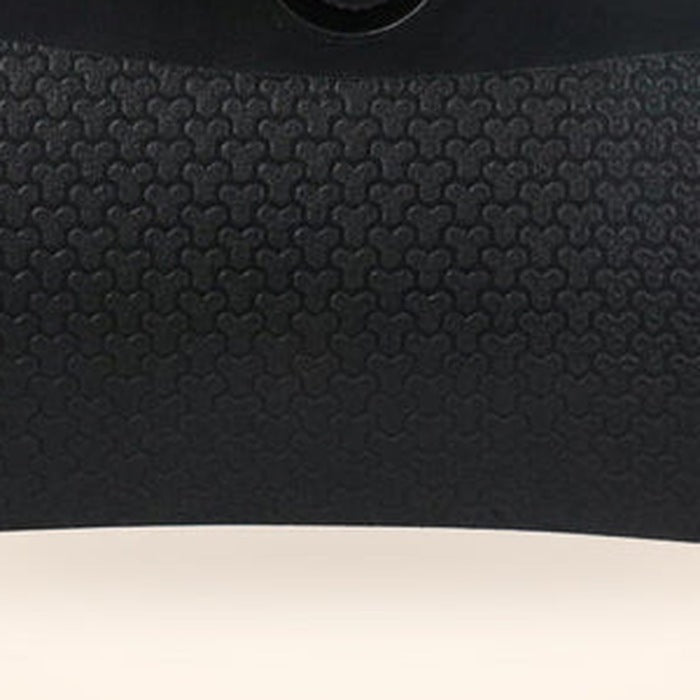 Close-up of the textured grip panel on the deshedding tool