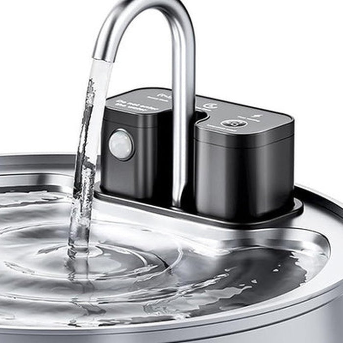Close-up of the fountain's curved faucet spout and pump modules