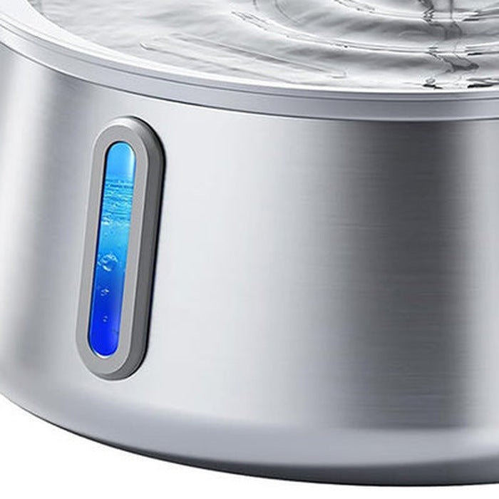 Close-up of the blue-lit water level window on the steel bowl