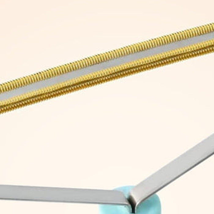 Close-up of the copper-toned ridged metal edge on the fabric rake