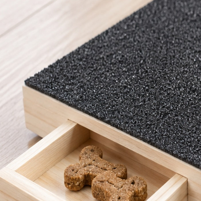 Close-up of the scratch board's wooden edge and drawer opening